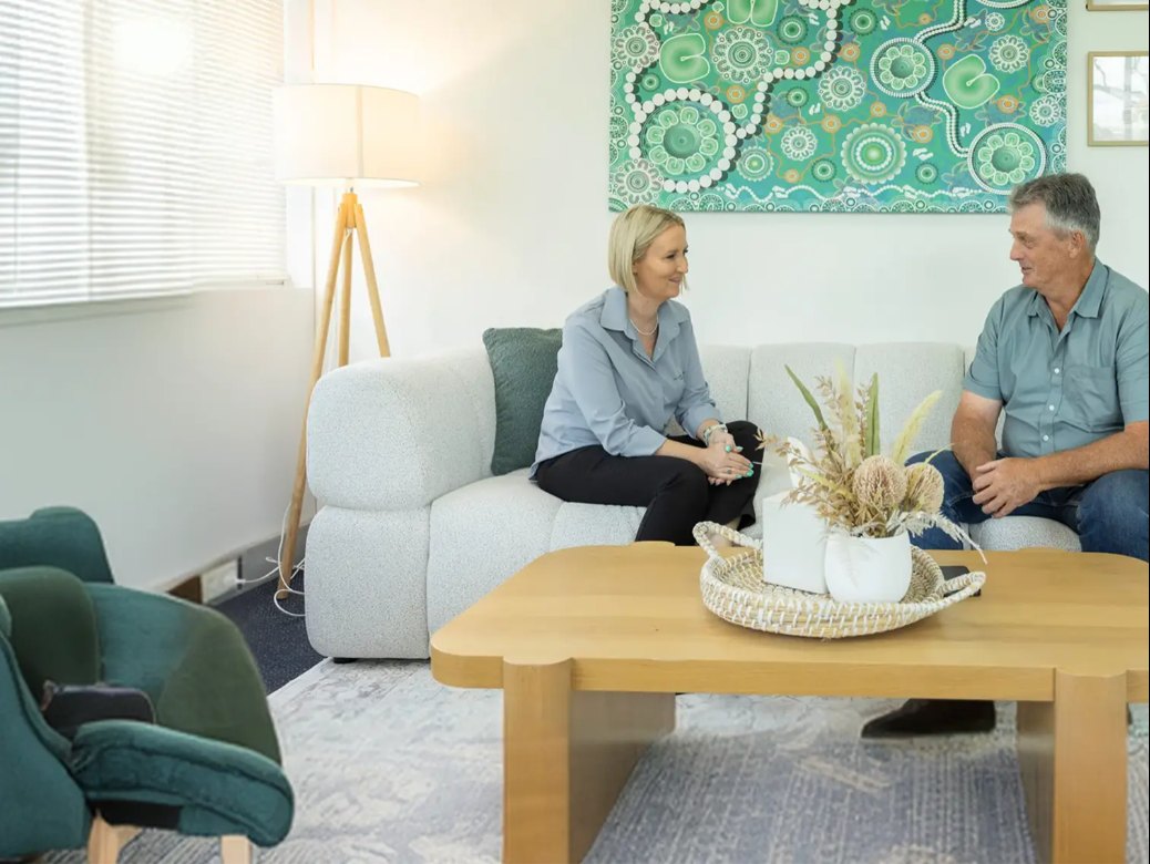 Rebecca Foley talking with a client in her mediation room